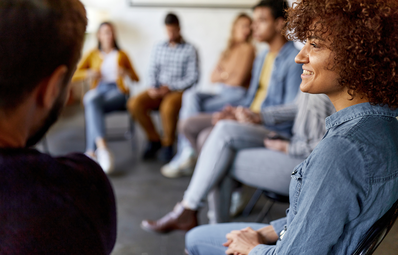 Smiling woman in group meeting